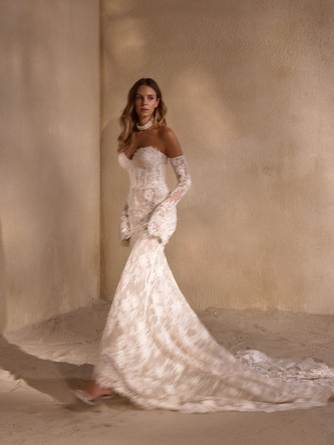 Ivory strapless wedding gown with sweetheart neckline, fitted lace bodice embellished with pearls and crystals, flowing pleated skirt with train