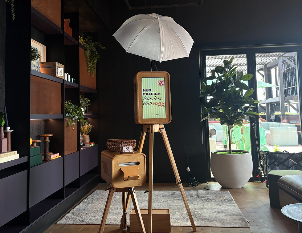 A&A Booths wooden photo booth and matching printer station set up with professional umbrella lighting inside a modern event venue.