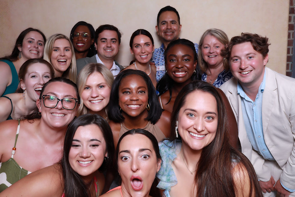 Large group of guests smiling together for an interactive group photo booth experience by A&A Booths.