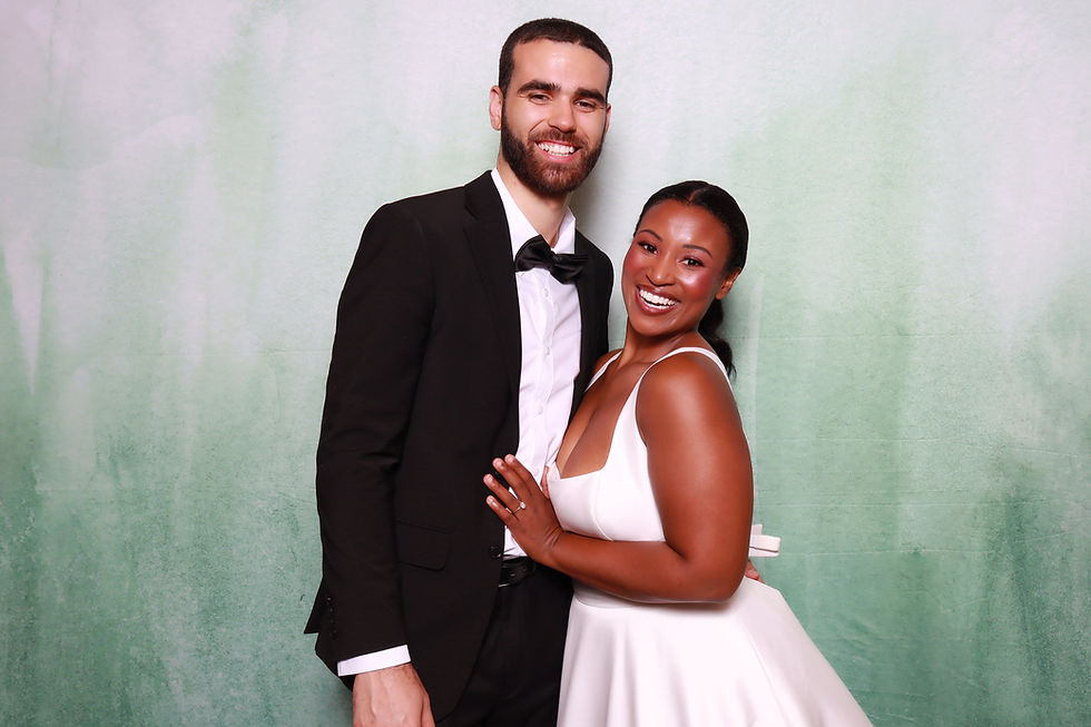 Couple enjoying a photo booth rental at a wedding in Raleigh, NC