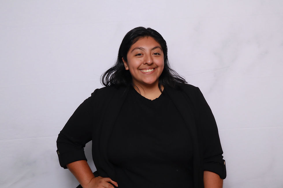 Karen, founder of A&A Booths, smiling in a black outfit against a light studio backdrop.