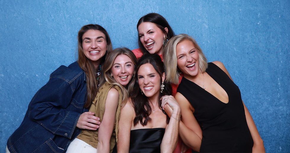 Group of friends using a photo booth at Maeve Raleigh apartments in Raleigh, NC