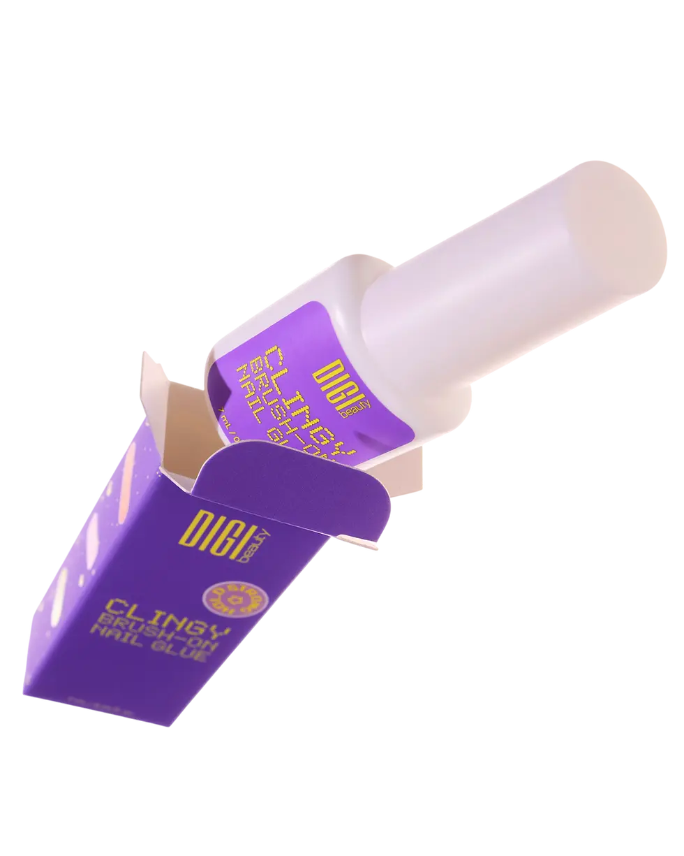 Packshot photography of a bottle and opened box for Digi Clingy brush-on nail glue. The product is set against a clean black background.