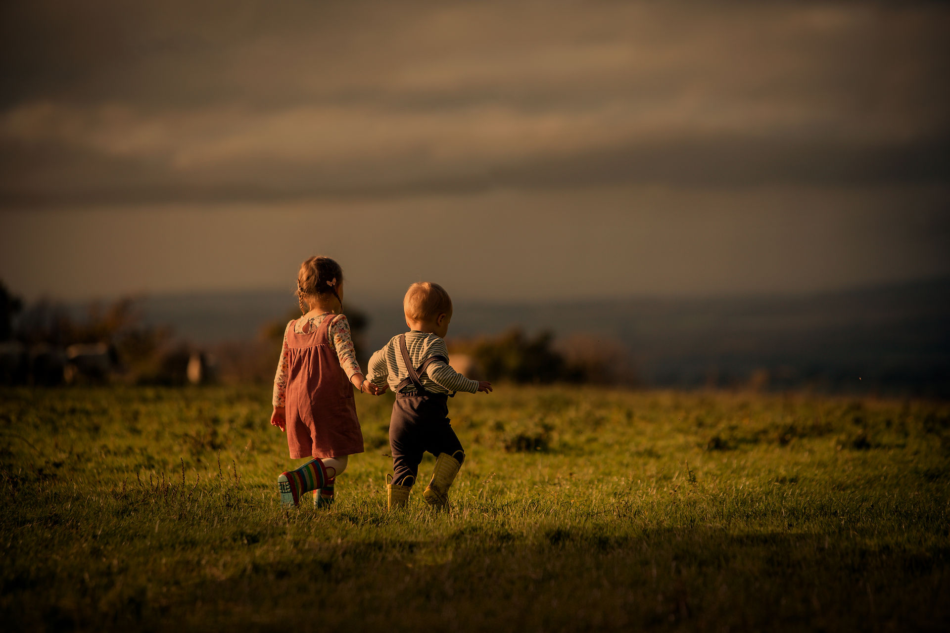 Siblings  holding hands
