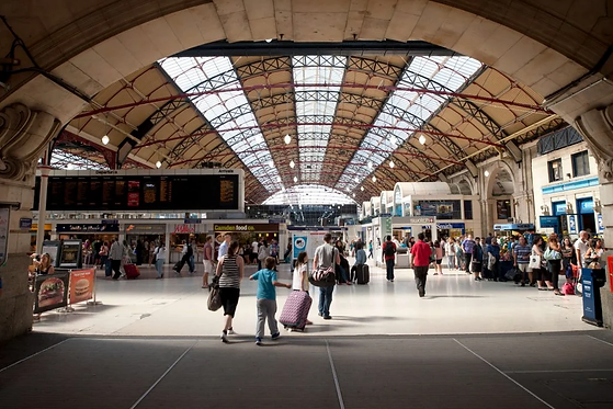 people in train station walking.webp
