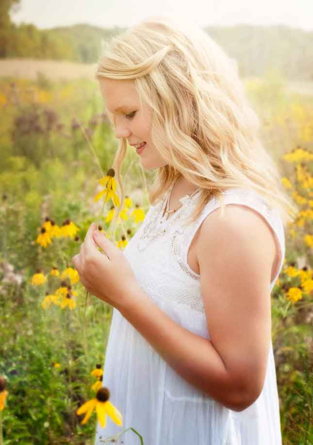 Teen girl in field of daisies