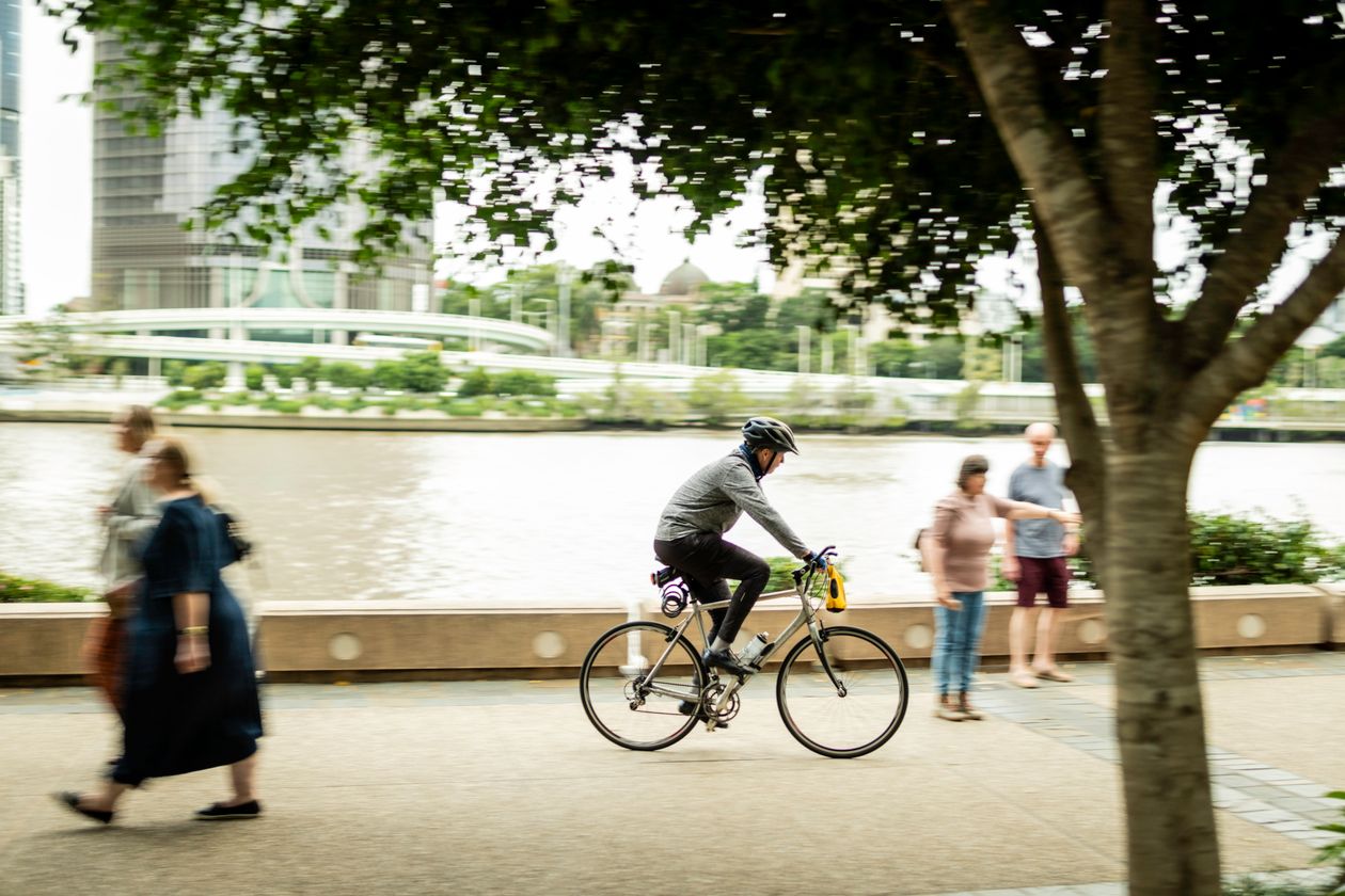 Cyclist riding along the riverside walkway in Brisbane, Queensland, Australia