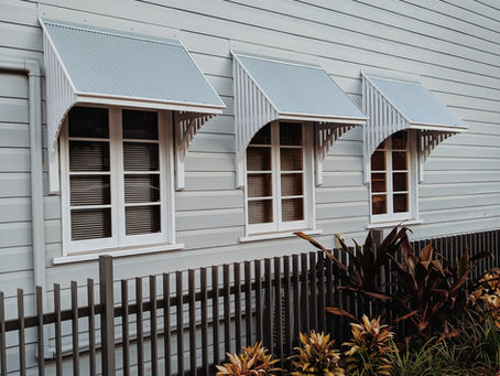 Traditional Queenslander-style rental property in Brisbane with timber weatherboard cladding and window awnings