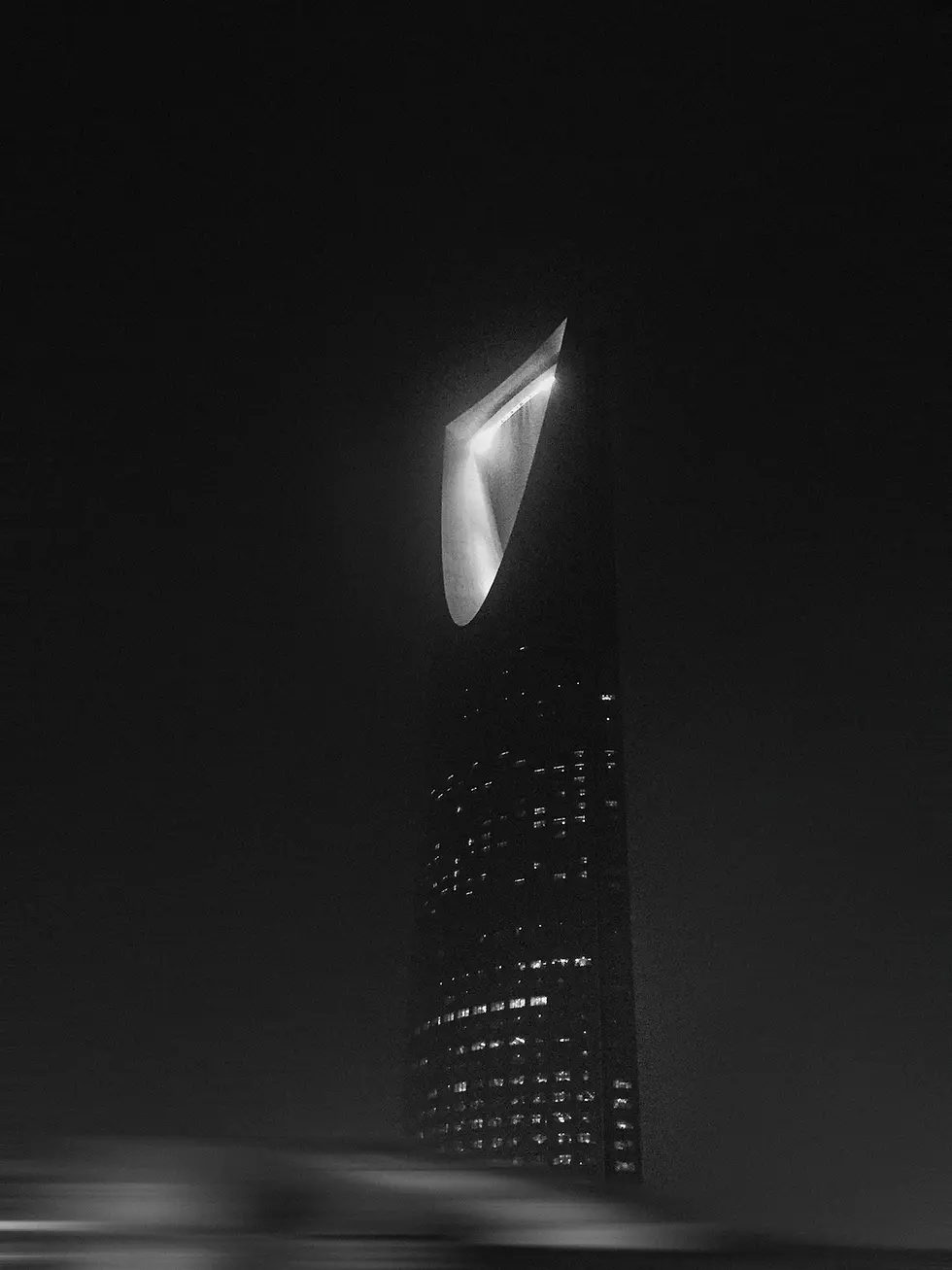 Black and white photograph of the illuminated Kingdom Tower piercing through the Saudi night sky. A minimalist, powerful composition capturing Riyadh’s architectural ambition and the transformative spirit of Saudi vision 2030. The image conveys mystery, modernity, and elevation — echoing PEAK Ventures' mission.