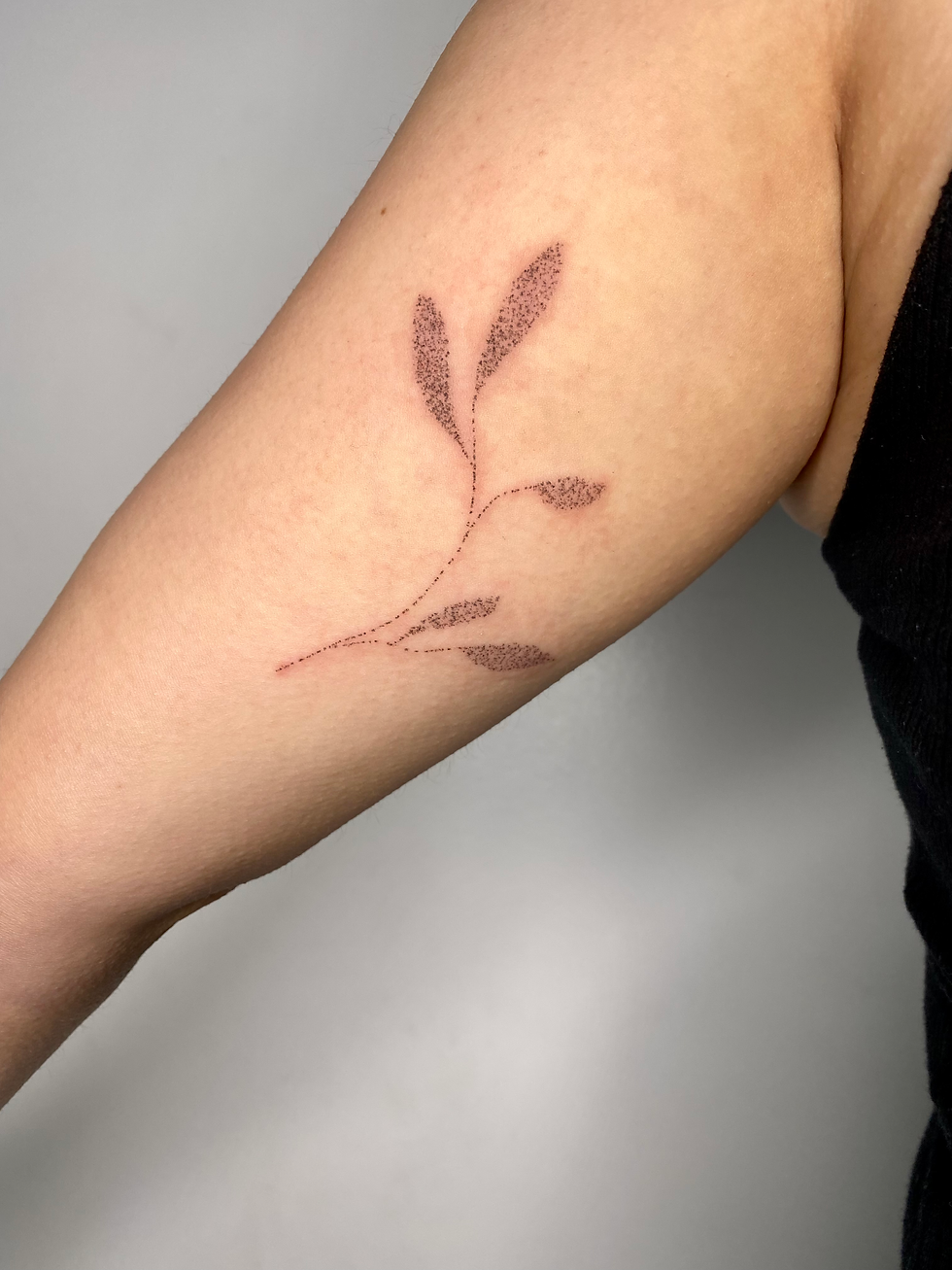 inner bicep delicate plant tattoo