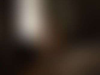 woman sits on chair at studio by Calgary boudoir photographer