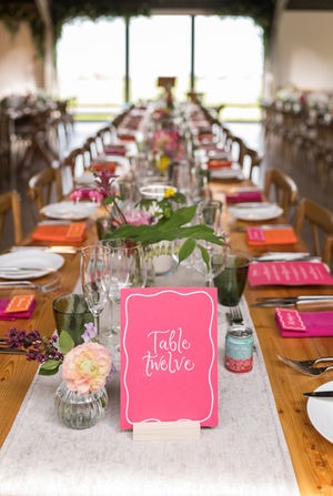 Bright Wedding Table Number signs. Bright Pink card with white hand-drawn borders and calligraphy

Photo credit: Suzanne Lister Photography. 
Shown at Cairns Farm, Edinburgh