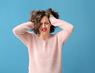 Portrait of beautiful stressed woman on color background.jpg