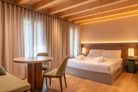 Rooms featuring a small living area and compact kitchen, offering independence and comfort for longer stays.