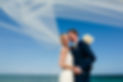 Happy bride and groom on beach, wedding veil