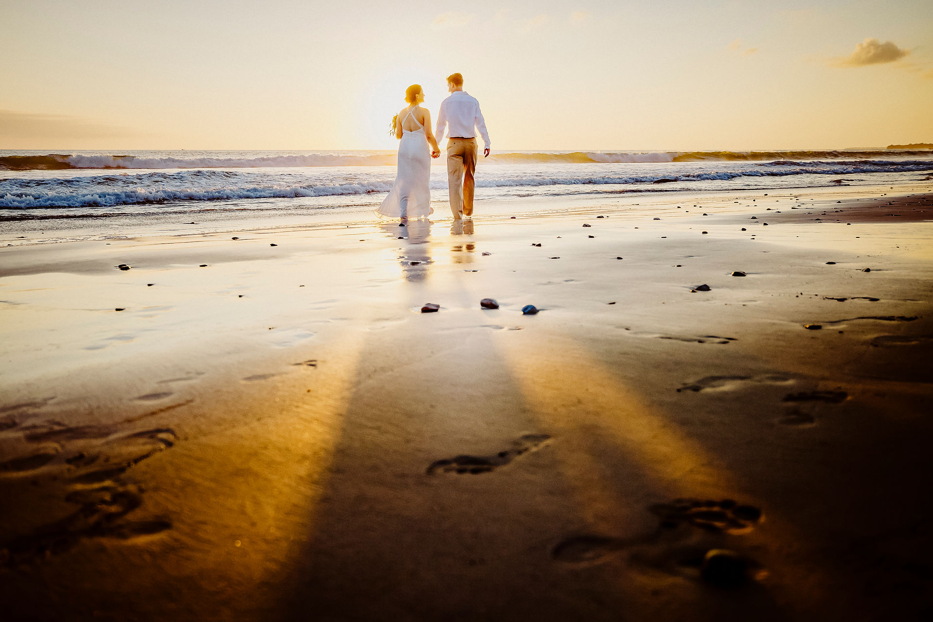 Couple walking on beach at sunset Marival Armony Punta de Mita