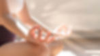 Close-up of a hand in a meditation pose with fingers touching, and the other hand slightly blurred in the background, at Trein Club in Houston