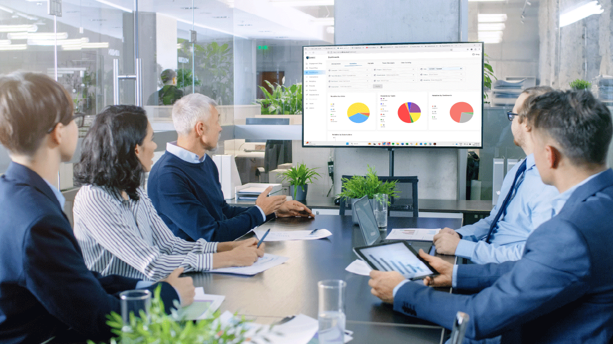 DIMEC team meeting with a dashboard tracking Tribal community interests in the U.S., featuring pie charts and GIS maps for consultation management.