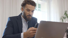 Professional following up by phone beside a laptop illustrating revenue leakage after buying an accounting practice