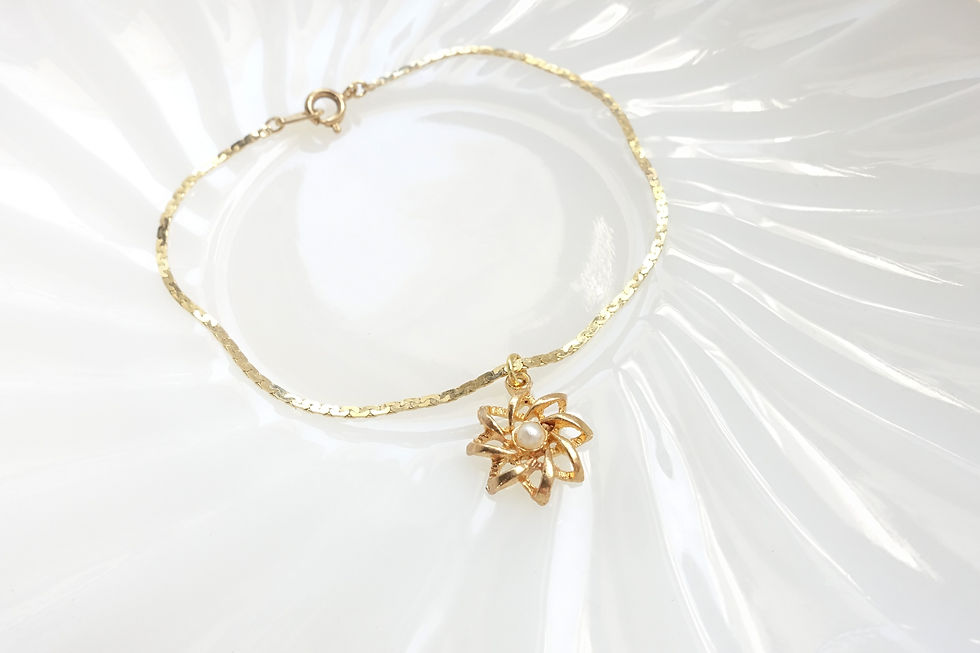 Floral charm gold tone bracelet