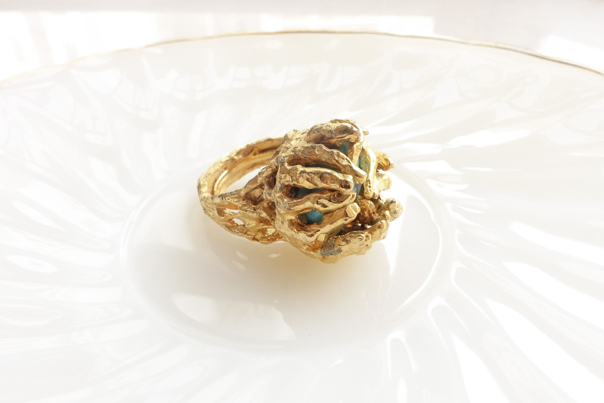 Rugged embraced turquoise center golden ring