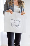Woman holding sign: Mental Load