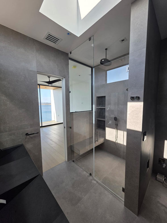 Frameless glass bathroom enclosure with modern chrome hardware
