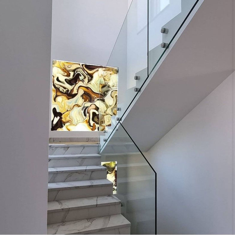 Frameless glass railing with silver button fasteners by Casali Group, designed for clean, modern architectural spaces