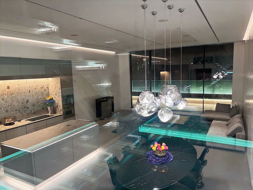 Boutique hotel penthouse in Boston featuring custom Casali glass exterior railing with unobstructed city views. High-end Boston hotel penthouse showcasing Casali glass applications including exterior railings, shower enclosures, and interior doors