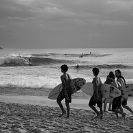 surfers in dreamland beach black and white photography