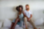 Wendy and Dan Hennessey holding each other on couch.
