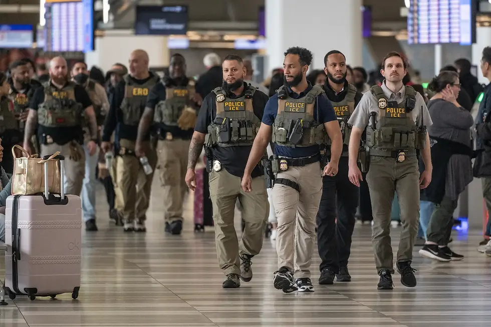 ICE agents walking through an airport.