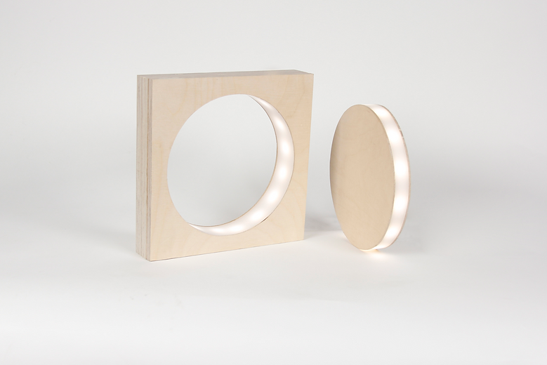 Sita magazine table featuring a curved tubular iron base and a beechwood tabletop with playful rounded contours, perfect for