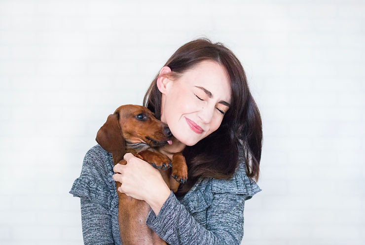 A woman hugging her Beagle dog