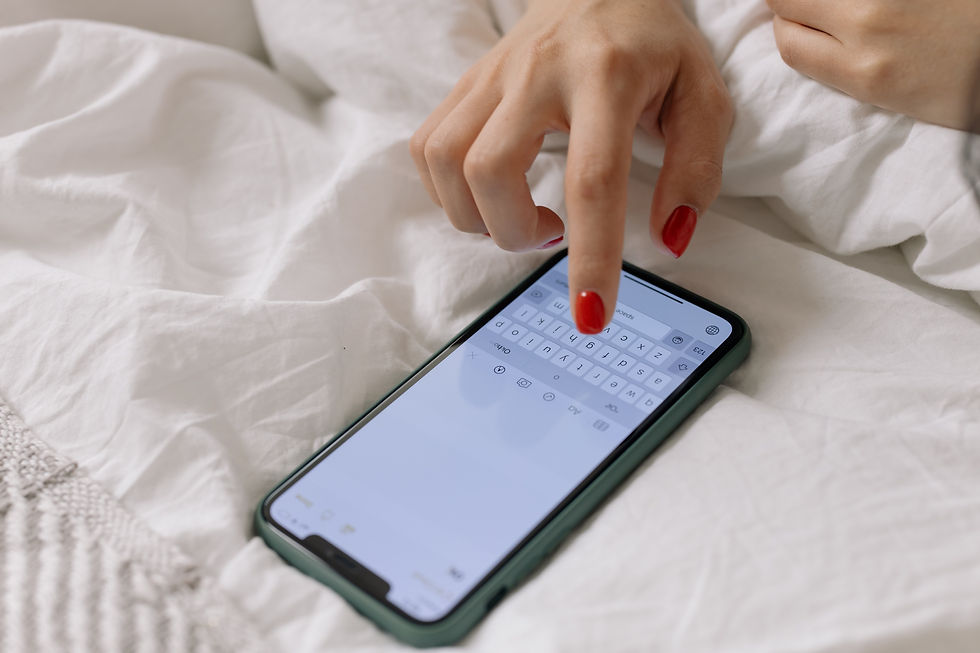 A woman in bed with red nails replying to a DM automation message she received