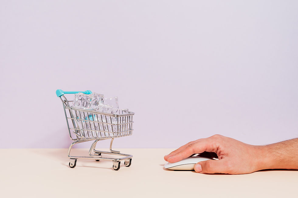 A man clicking on a mouse with a mini trolley in front of it