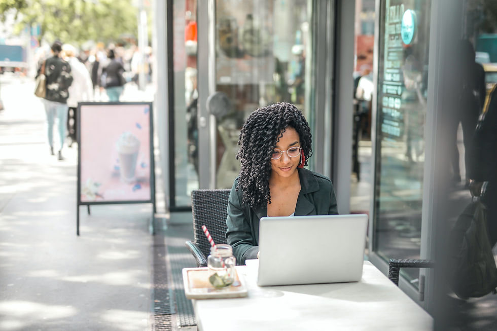 A woman sitting in a cafe and working on her laptop