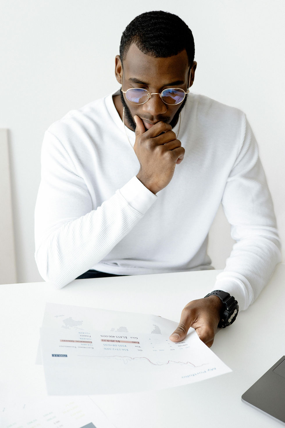 A man looking at papers after researching his target audience and competitors
