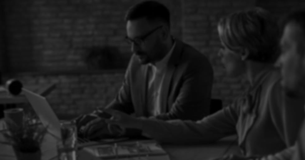 three business professionals working on a project together with a laptop