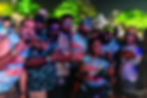 Men in 'Bull Tuskers' shirts smiling at night event