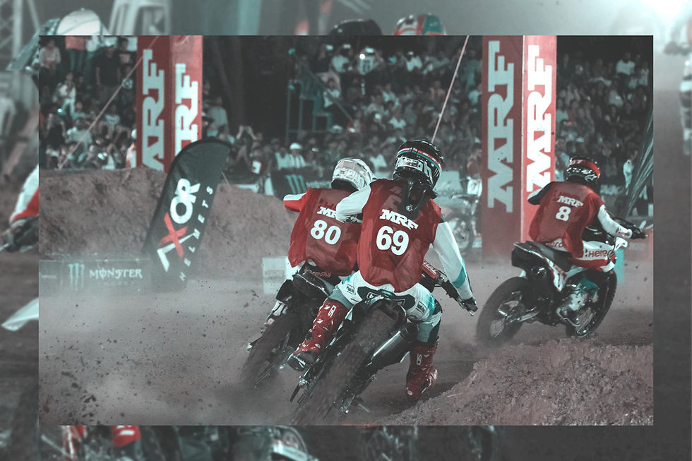 Motocross riders racing on a dusty track