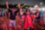Two men with raised arms at an outdoor event