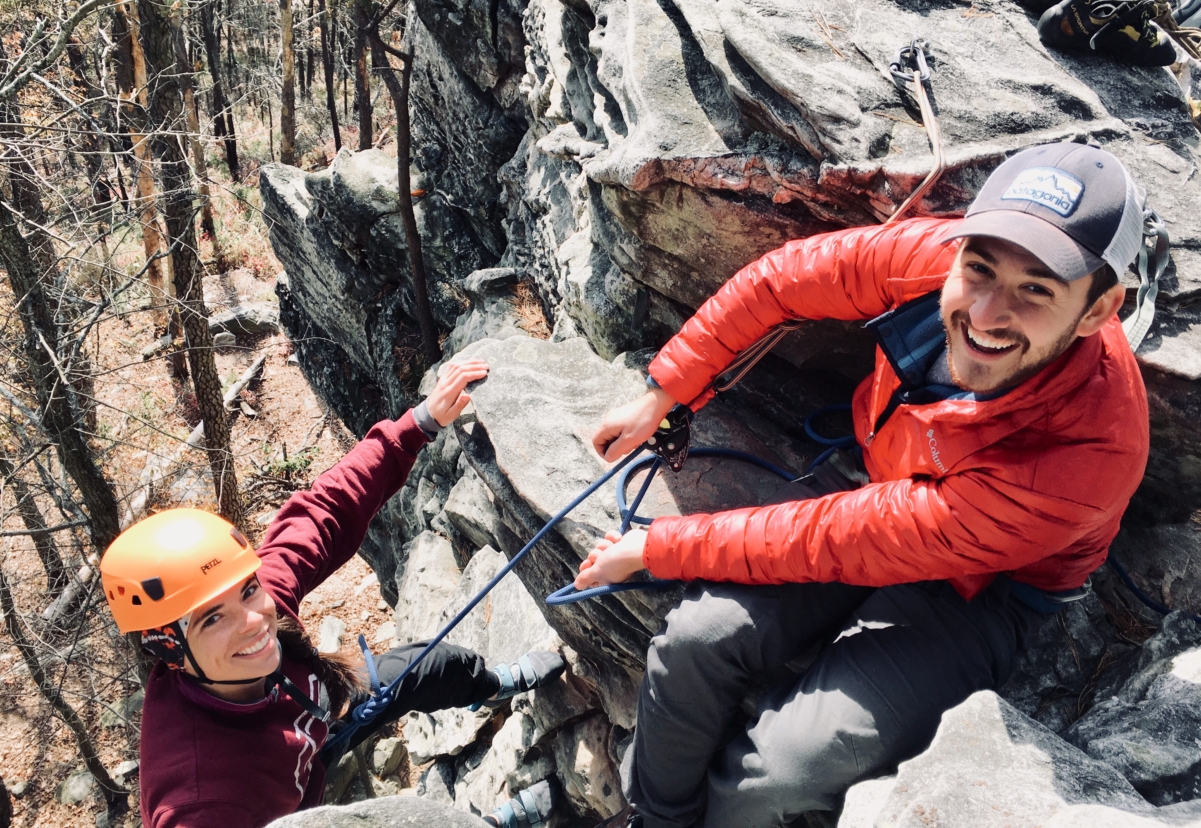 Man and woman rock climbing outdoors