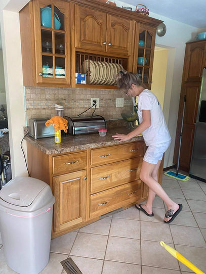 Woman cleaning a kitchen countertop