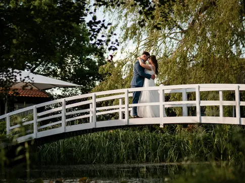 Wedding Couple Posing on a Bridge at a wedding venue is Essex