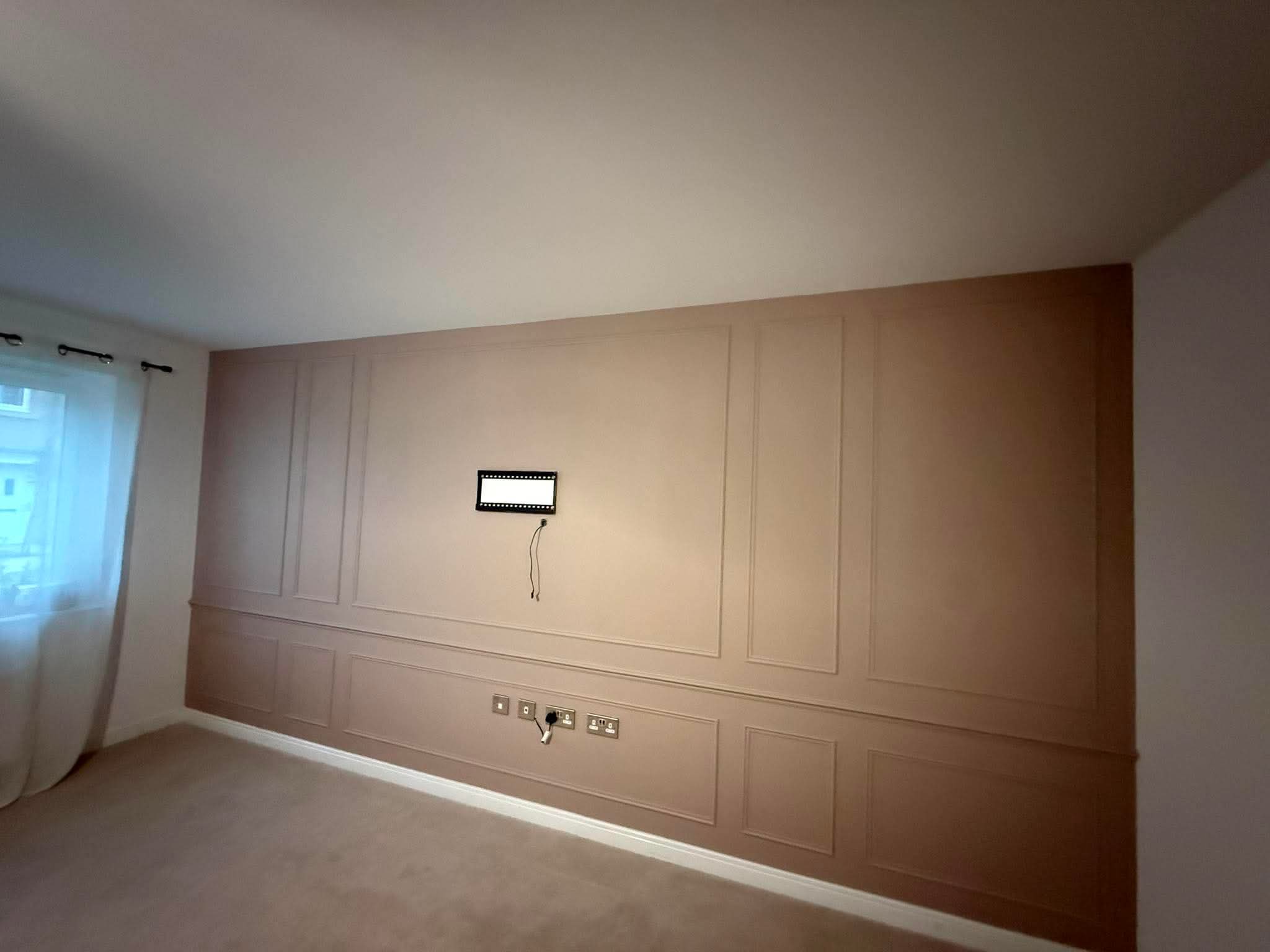Decorative panelling fitted around the TV position
