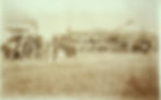Historic farm harvest with steam tractor and workers