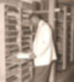 Man reading a book in an archive