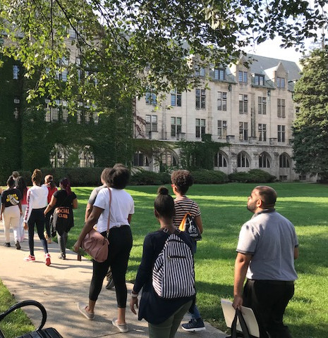 Students walking on a sunny college campus path