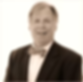 Man in suit and bow tie smiling